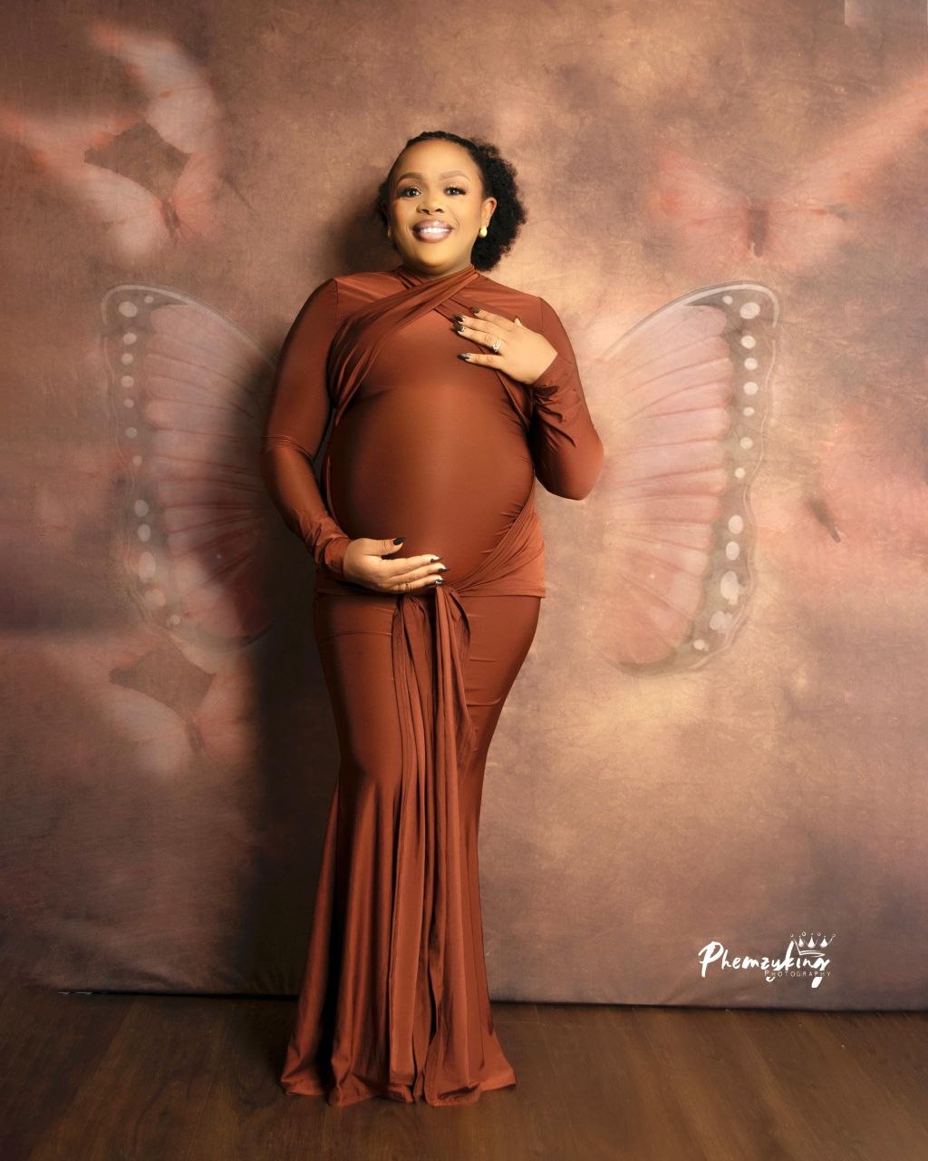 Maternity portrait with butterfly backdrop