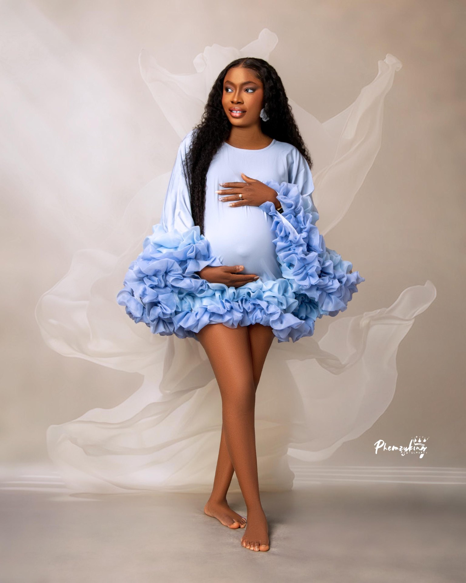 Maternity portrait in blue ruffled dress
